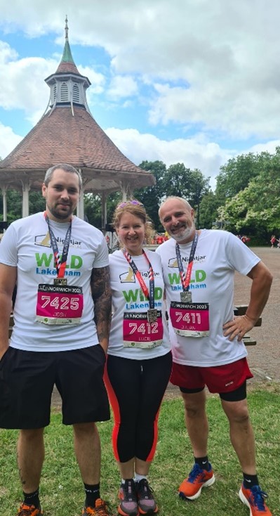 3 Runners proudly displaying their medals